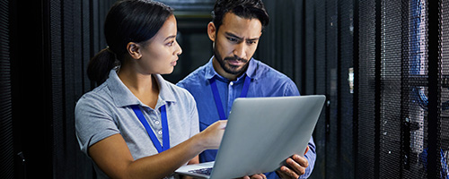 coworkers looking at a laptop