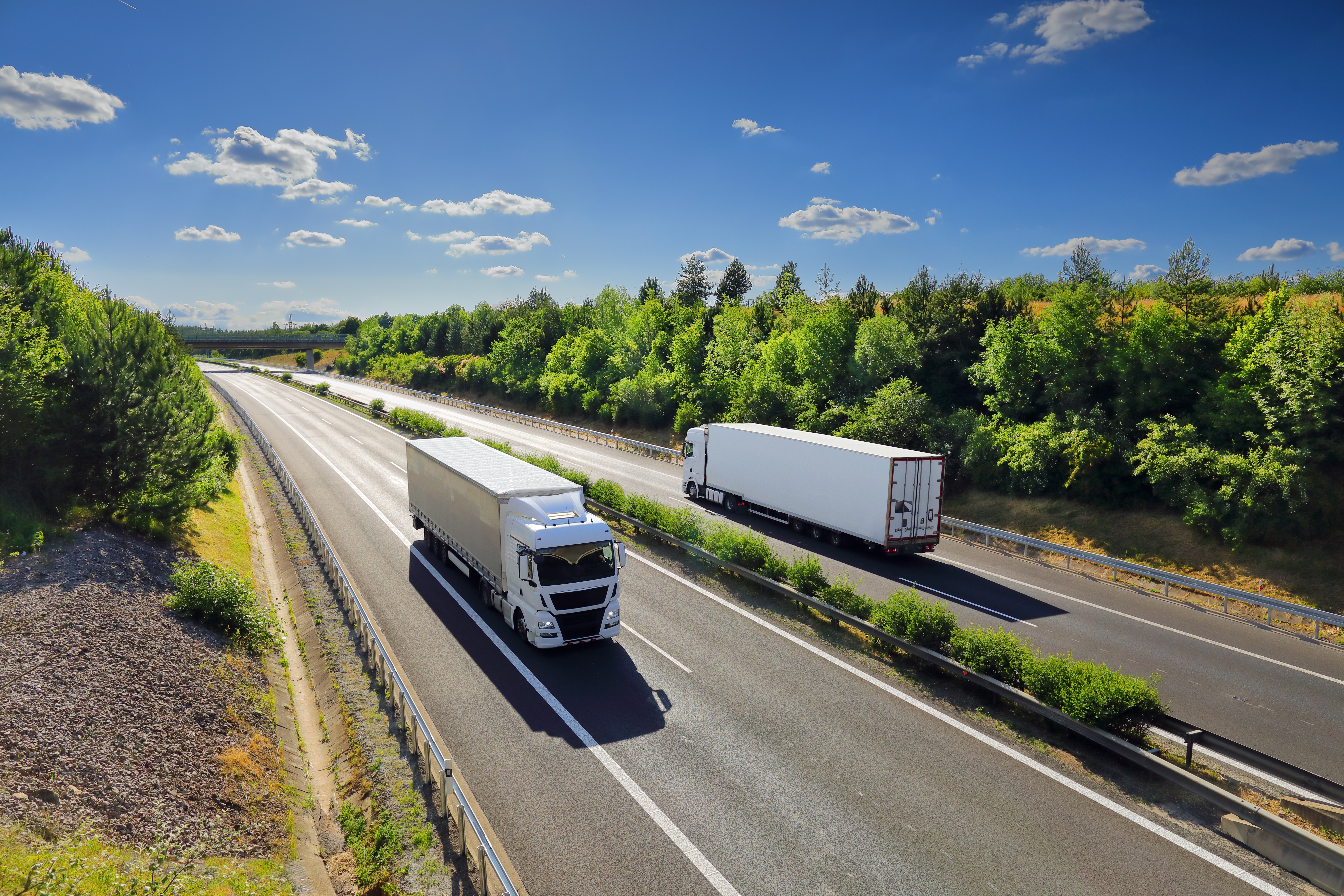 Two semi trucks passing each other on the interstate